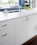 White kitchen cabinets with Champagne Bronze Cabinet Pulls 4 Inch Center To Center 5 Pack Drawer Handles, zinc finish installed.