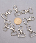 Legit Heavy Duty Swivel Hook Clasps 40 Piece Kit 1 Inch D Ring Connectors For Lanyards Bags And Craft Projects Solid Metal Build, nine shiny nickel-plated clips with coin.