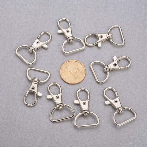 Legit Heavy Duty Swivel Hook Clasps 40 Piece Kit 1 Inch D Ring Connectors For Lanyards Bags And Craft Projects Solid Metal Build, nine shiny nickel-plated clips with coin.
