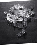 Beefy Plastic Locking Shelf Support Pegs With Smooth Grip Tops For Cupboards Medicine Cabinets And Glass Drink Stands A Top Grade Thirty Piece Cabinet Hardware Fix That Swaps Out Quick And Stays Put, clear plastic pegs laid on a dark surface.