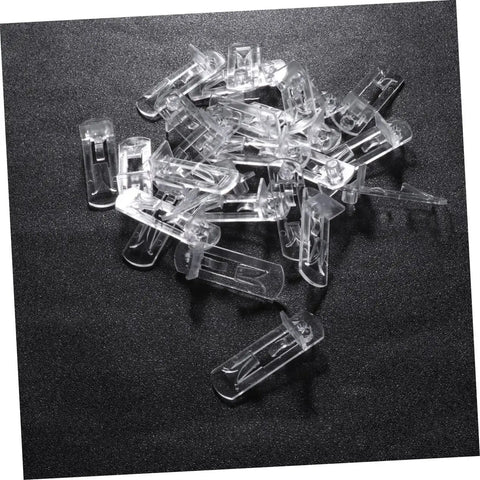 Beefy Plastic Locking Shelf Support Pegs With Smooth Grip Tops For Cupboards Medicine Cabinets And Glass Drink Stands A Top Grade Thirty Piece Cabinet Hardware Fix That Swaps Out Quick And Stays Put, clear plastic pegs laid on a dark surface.