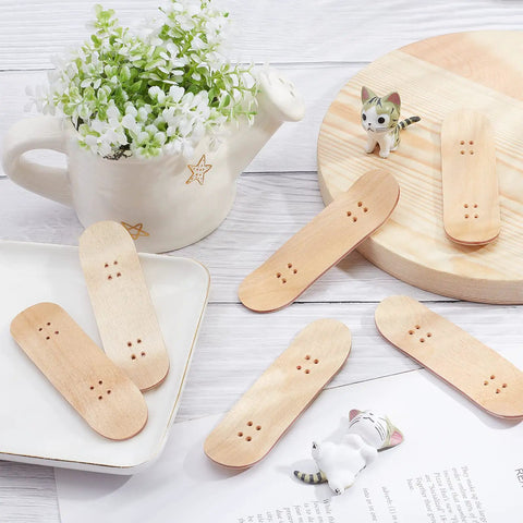 8 Pack Mini Fingerboard Set Maple Wood With Plastic Case Tiny Skateboards arranged on a table for desk tricks and fun.