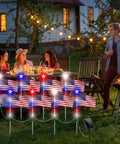 Outdoor gathering with Lit Patriotic Solar Flag Lights For Outdoors, 8 Pack Pathway Stakes illuminating a yard scene