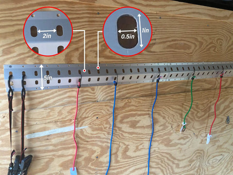 36 Inch Trailer Track Tie Down System With E Track S Track And L Track Anchors mounted on a wooden wall holding straps