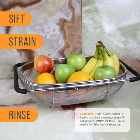 6-Quart Over The Sink Stainless Steel Colander With Expandable Rubber Handles filled with assorted fruits on a marble surface