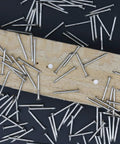 900 Pack Three Quarter Inch Nickel Plated Flat Finish Nails With Rust Proof Coating placed on wood for DIY projects.