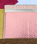 Pink bubble mailers and an open red envelope. 25 Pack Self Seal Bubble Mailer Envelopes 25x20cm Padded Cushion Mailing Bags For Shipping Cosmetics Jewelry Bulbs