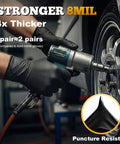 TitanFlex heavy-duty black nitrile gloves, 8-mil, XL, raised diamond texture, worn by a mechanic servicing a car wheel
