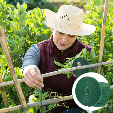 Person using Reusable Green Plant Tape For Climbing Plants, 6 Rolls, 196 Ft Total, Adjustable Soft Garden Ties outdoors in garden.