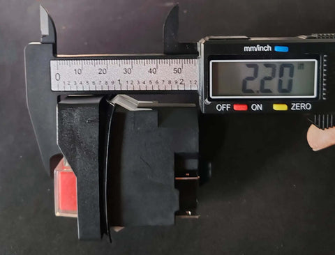 Close-up of 4-pin electromagnetic pushbutton switch being measured, part of the Electromagnetic Pushbutton Switch Set, 2 pack.