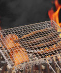 Extra Large Grill Basket For Outdoor Grillin With Detachable Handle showing grilling fish over open flames on barbecue rack.