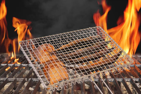 Extra Large Grill Basket For Outdoor Grillin With Detachable Handle showing grilling fish over open flames on barbecue rack.