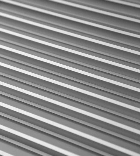 Close-up view of Aluminum Privacy HVAC Air Grille 24 By 24 With V Shaped Louvers Blocks 100 Percent View While Allowing Air Flow.