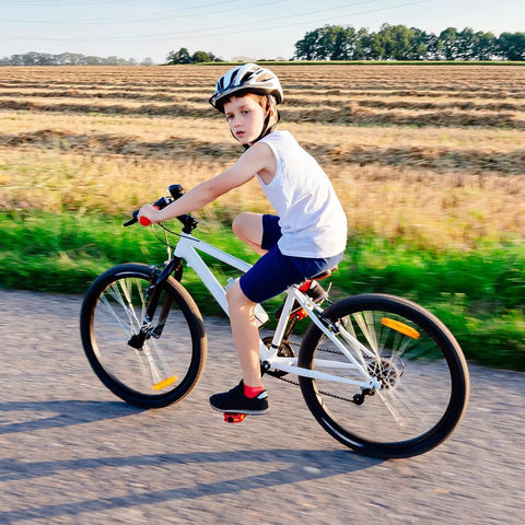Child riding a bike on a rural path, showcasing Two Pack 20 Inch Bike Inner Tubes For 20x1.50 Or 20x1.75 Tires Fits ETRTO 40 47 406 With AV32mm Schrader Valve Premium Butyl Rubber Durable And Leak Free Sealing Nice Replacement For Road And City Bikes