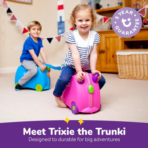 Kids enjoying ride-on luggage in playroom; kids ride-on luggage