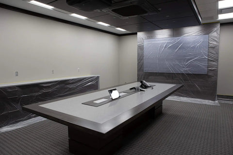 Conference room with walls covered using Pre-Taped Masking Film With Built-In Three Quarters Inch Tape, 0.5 Mil Thick Protective Film.