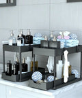 Heavy Duty Black Under Sink Organizer 2 Pack with Smooth Glide Sliding Drawers for Bathroom Cabinet used to store toiletries.