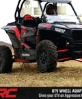 Upgrade Your Polaris UTV Setup With These Heavy Duty 4x156 To 4x136 Wheel Adapters That Drop Your Can Am Rims A Full Inch For Wide Tire Flex Meaner Fitments And Fresh Off Road Stance In Pairs with a Polaris UTV on rough terrain.