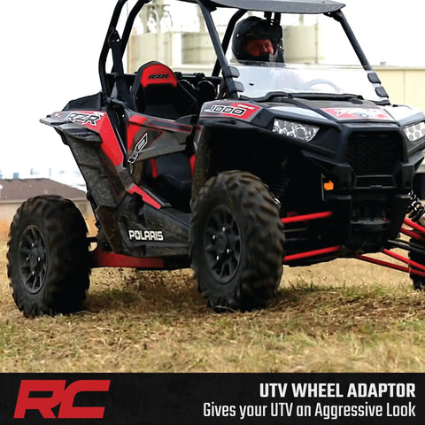 Upgrade Your Polaris UTV Setup With These Heavy Duty 4x156 To 4x136 Wheel Adapters That Drop Your Can Am Rims A Full Inch For Wide Tire Flex Meaner Fitments And Fresh Off Road Stance In Pairs with a Polaris UTV on rough terrain.