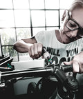 Person using Kraftform Torque Screwdriver Set With Rapidaptor Bitholder, 0.3-6.0 Nm, 27 Pieces on bicycle handlebars indoors.