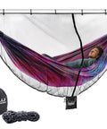 Person relaxing in a hammock covered by a 12ft Lightweight Hammock Bug Net for Camping, Easy Setup, Ultra Breathable 360 Degree Coverage.