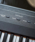 Close-up of Beast 88 Key Semi Weighted Digital Piano Keyboard With Built In Forty Watt Stereo Speakers Voice Select panel.