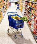 Blue shopping cart with groceries in a supermarket aisle, featuring lettuce, fruits, and cereal boxes.
