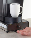 Hand using Rolling Mini Black Finish K Cup Drawer Organizer For Under Coffee Pot Storage 24 Pod Pack Holder Slim Compact Counter