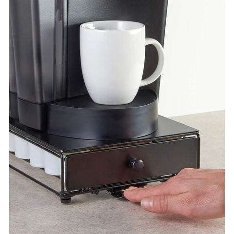 Hand using Rolling Mini Black Finish K Cup Drawer Organizer For Under Coffee Pot Storage 24 Pod Pack Holder Slim Compact Counter