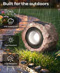 Two Pack Solar Rock Lights Outdoor Adjustable Angle Waterproof LED Garden Pathway Lights in stone design under rain