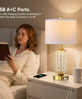 Set Of 2 Dope Gold Table Lamps With USB A And C Ports And Built In Night Light in bedroom with woman reading