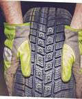 Killer Winter Tire Studs For Cars Trucks And Motorcycles Tungsten Steel Spikes installed in tire tread with gloved hands.