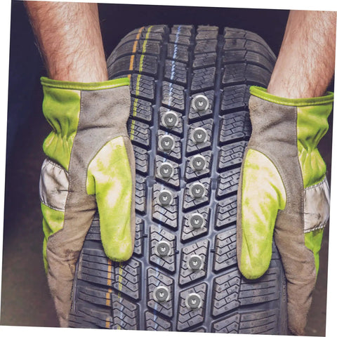 Killer Winter Tire Studs For Cars Trucks And Motorcycles Tungsten Steel Spikes installed in tire tread with gloved hands.
