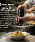 Chef using Unicorn Pepper Mill By Tre Spade Premium Kickin Manual Pepper Grinder With Steel Burrs over pasta in kitchen