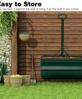 Beast Of A Lawn Roller For Yard And Garden Push Or Tow Behind 30 Gallon Water Sand Filled Sod Roller Drum resting against a shed