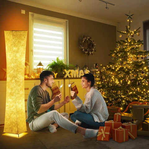 Tall Dimmable Floor Lamp With White Fabric Shade 64 Inch Standing Light Two 12W LED Bulbs 3 Brightness Levels Cozy Vibe 2700K Ambient Glow Modern Home Decor For Living Room Bedroom Kids Room next to Christmas tree and couple.