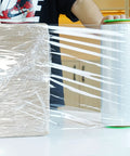 Two Pack Clear Stretch Film 12 X 1000 Feet 80 Gauge Heavy Duty Self Adhering Plastic Wrap With Handles securing a box.
