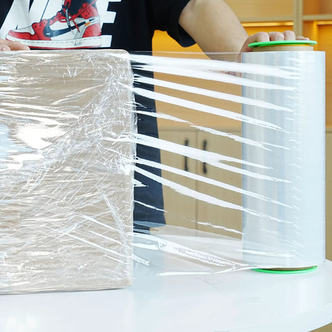 Two Pack Clear Stretch Film 12 X 1000 Feet 80 Gauge Heavy Duty Self Adhering Plastic Wrap With Handles securing a box.