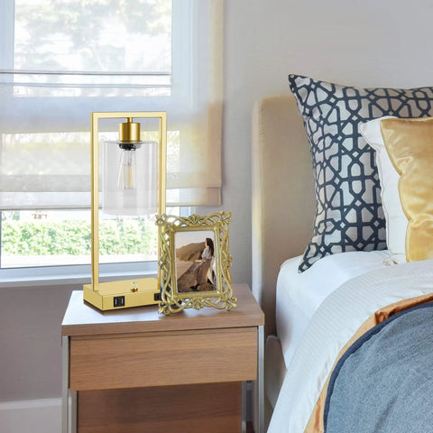 Industrial Table Lamp Set Of 2 With Gold Finish, Dimmable Nightstand Lamps, USB Ports And AC Outlet, Clear Glass Shade, LED Bulbs Included, Perfect For Bedroom Or Living Room Vibe, Sturdy Rectangular Base on a nightstand.