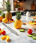 Stainless Steel Pineapple Eye Remover Tool With V Shaped Cutter And Ergonomic Handle For Home Kitchen Prep on countertop with fruit