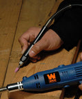 WEN 2305 rotary tool with flex shaft, blue handheld power tool on a wooden workbench