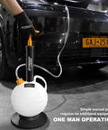 Grip Tight 6 Liter Manual Oil Extractor Pump for Swift Engine Oil Changes Via Dipstick Tube with white vacuum tank in use.