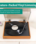 Electrohome Montrose Vinyl Record Player With Belt Drive Turntable and Audio-Technica Stylus in wood finish, playing vinyl record.