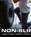 Person wearing All Day Comfort Knee Pads with Anti Slip Straps kneeling next to a tire, showcasing non-slip feature in outdoor setting.
