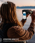 Person using Smartphone Photo Rig II Attachment For Binoculars And Telescopes at sunset lake view