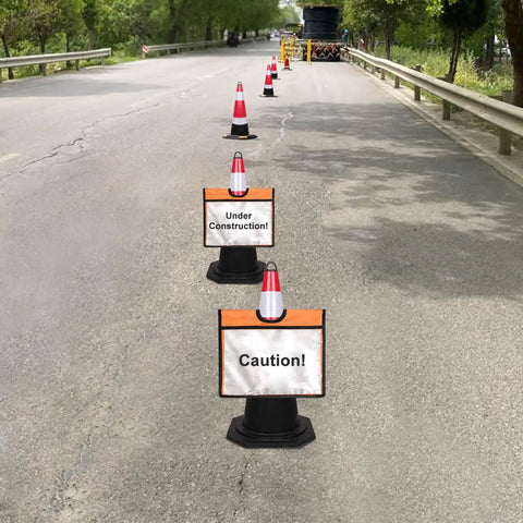 Traffic cones with Six Pack Orange Traffic Cone Sleeves With Pockets For Caution Signs And Outdoor Safety Signals along a road.
