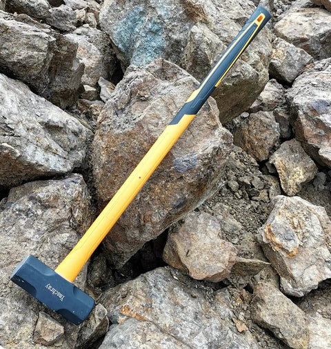 10 Pound Sledge Hammer for Heavy Duty Demolition with 35 Inch Fiberglass Handle resting on rocks