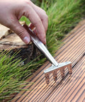 Using stainless steel hand rake from Three Piece Mini Garden Tools Set on deck for succulents, potted flowers, and seedlings care.