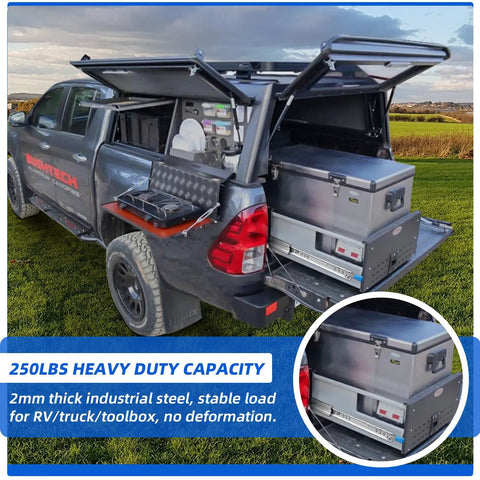 Truck with open storage compartments, showing 250 lb capacity heavy duty drawers and toolbox on a field background.