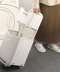 Person using collapsible wall hanging laundry baskets space saver duo set with hidden pull rod by washing machine.